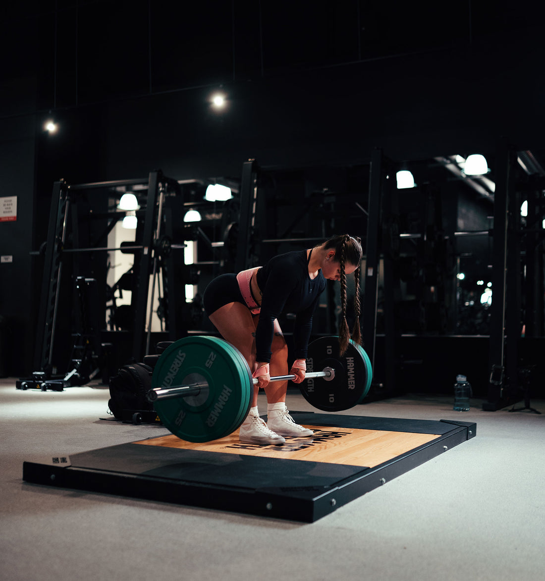 woman doing a deep squat with a barbell