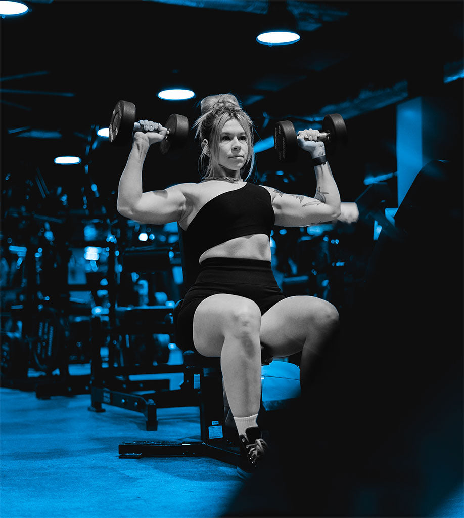 blue image of iulia doing shoulder presses