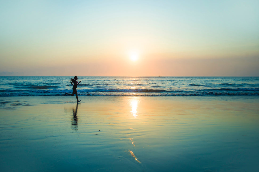 woman running on beach for rest day