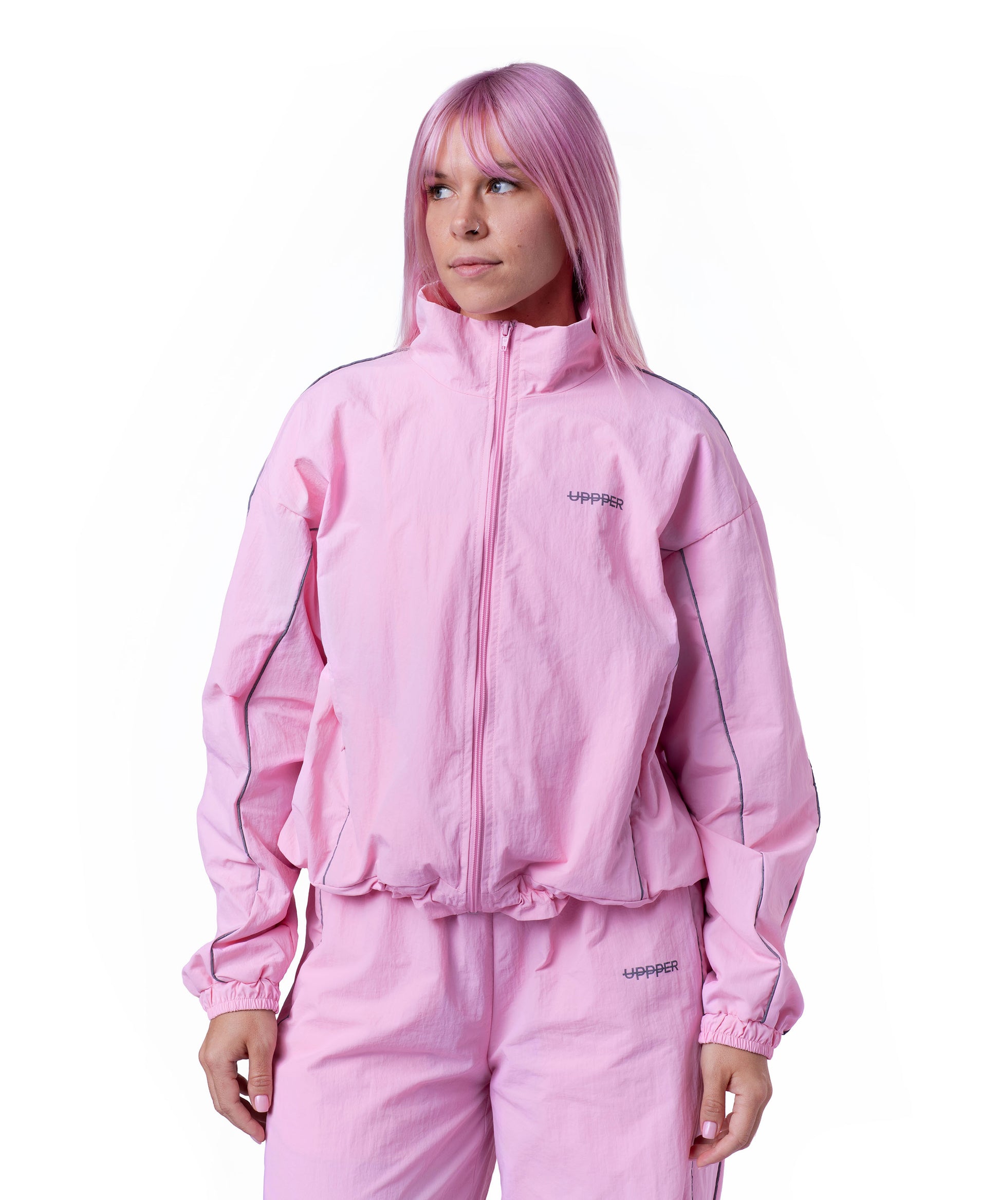 front of pink uppper track jacket with reflective stripe detail on white background